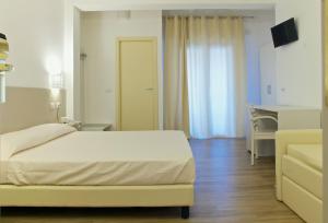 Rúm í herbergi á Hotel Nettuno