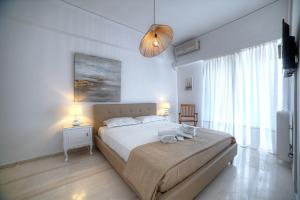 Posteľ alebo postele v izbe v ubytovaní L'appartement blanc dans le centre de Glyfada