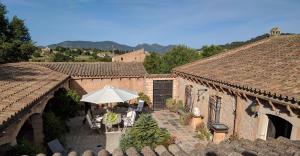 an outdoor patio with a table and an umbrella at Finca Sa Tafona in Son Servera