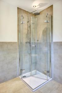 a shower with a glass door in a bathroom at Pension Haus am Einberg in Meschede