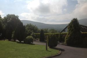 a garden with a view of a mountain in the distance at Eden House in Carlingford