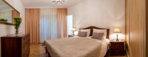 a bedroom with a bed with two lamps and a dresser at Apartments Emi in Split