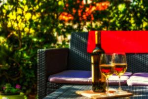 a bottle of wine and two glasses on a table at Apartments Emi in Split
