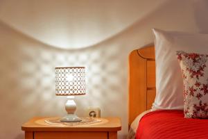 a lamp on a night stand next to a bed at Apartments Emi in Split
