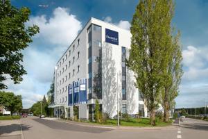 a large white building on the side of a street at Essential by Dorint Stuttgart/Airport in Leinfelden-Echterdingen