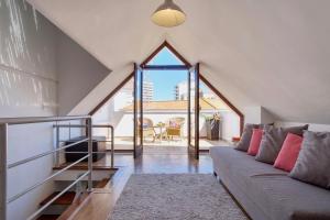 a living room with a couch and a large window at Casa da Avó in Faro