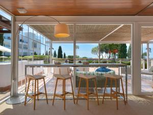 a kitchen and dining area with a table and chairs at Hotel Fuerte Conil-Resort in Conil de la Frontera +41 photos