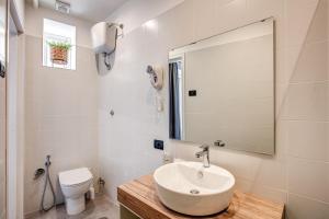 a bathroom with a sink and a toilet and a mirror at Hotel King in Rome