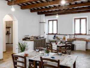 a kitchen and dining room with tables and chairs at ValleChiara B&B in Recanati