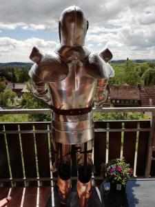 a statue of a man in a suit on a balcony at Jagdschlösschen-Harz in Bad Sachsa