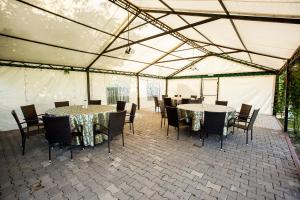 a dining tent with tables and chairs in it at Magic Garden by Vlăduț in Bacău