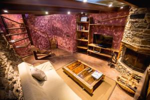 an overhead view of a living room with a stone fireplace at R de rural - Casa Mariola in Ordino