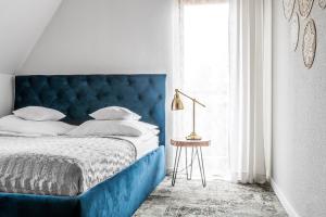 een blauw bed met een blauw hoofdeinde in een slaapkamer bij Willa Olga in Zakopane