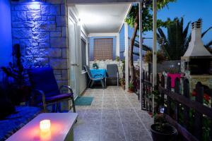 a patio with chairs and a table with a candle at Blue Heaven in Hersonissos