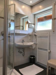 a bathroom with a sink and a shower at Pension Glöcklehof in Todtnauberg