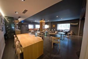 a restaurant with tables and chairs in a room at Aparthotel Atenea Valles in Granollers