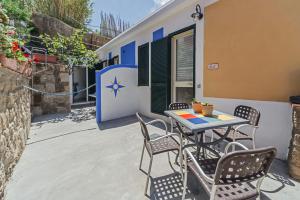 a patio with a table and chairs in front of a house at Eolo Ventotene in Ventotene
