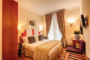 a hotel room with a bed and a window at Hotel Cortina in Rome
