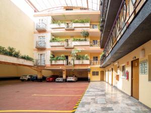 an empty parking lot in a building with plants at Hotel Santa Maria in Mexico City