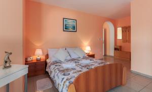 a bedroom with a bed with two night stands and two lamps at Apartments Dora in Medulin