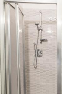 a shower in a bathroom with a glass door at Hotel Sabrina in Sottomarina