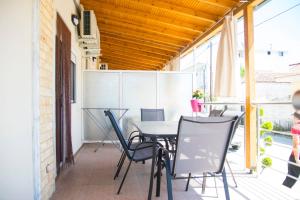 an outdoor patio with a table and chairs at Villa Filimon in Nea Vrasna