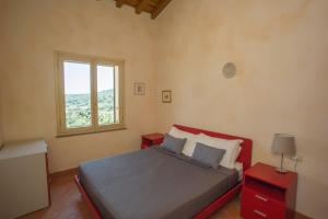 a bedroom with a bed with two tables and a window at Il Casale in Capoliveri
