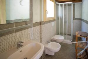 a bathroom with a sink and a toilet at Il Casale in Capoliveri
