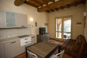 a kitchen with a table and a dining room at Il Casale in Capoliveri +32 photos