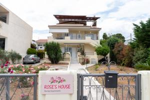 a house with a roses house sign in front of it at Rose's House (Near Airport) in Artemida