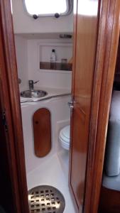 a small bathroom with a toilet and a sink at Velero MissTick,Gibsea 47'2 in Puerto Calero