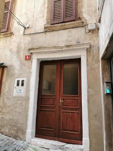 a building with a wooden door on the side of it at Apartment Niko in Piran