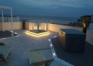 a deck with lights on the side of a building at Luxor e Cairo The Beach Resort in Lido di Jesolo