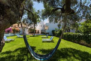 a hammock hanging from a tree in a yard at Emerald Hotel in Malia