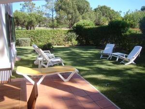 a group of lawn chairs sitting on a patio at SOLAR DO GOLFE - Vilamoura in Vilamoura