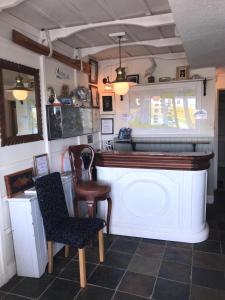 a bar in a room with a table and chairs at Westend Bar & Restaurant in Fenit
