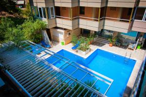 an overhead view of a swimming pool in front of a building at Apollonia Hotel Apartments in Varkiza