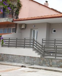 a house with a fence and a porch at Chriselia 1 in Nea Roda