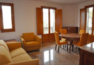 a living room with a table and chairs at Appartamenti fronte mare in Castiglioncello