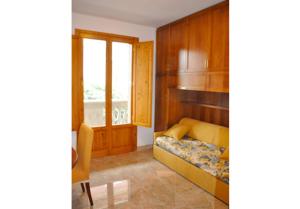 a bedroom with a bed and a window at Appartamenti fronte mare in Castiglioncello