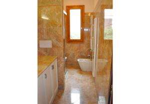 a bathroom with a tub and a sink at Appartamenti fronte mare in Castiglioncello +25 photos