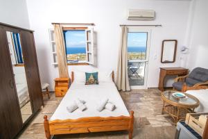 A bed or beds in a room at Stelios Rooms