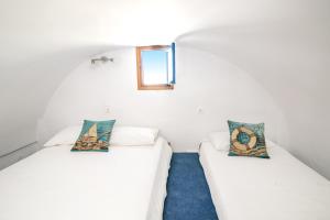 A bed or beds in a room at Stelios Rooms