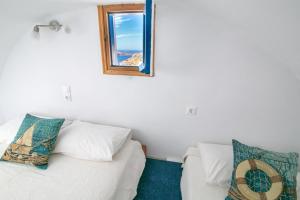 A bed or beds in a room at Stelios Rooms