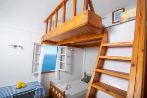 A bed or beds in a room at Stelios Rooms