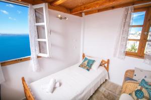 A bed or beds in a room at Stelios Rooms