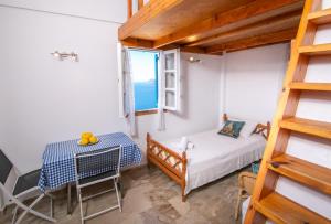 A bed or beds in a room at Stelios Rooms