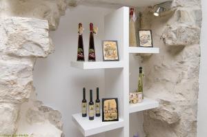 a wall with shelves with wine bottles on it at Villa Toni Design Apartments in Split