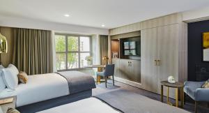 a hotel room with a bed and a desk at InterContinental Lyon - Hotel Dieu by IHG in Lyon
