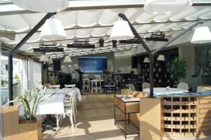 a restaurant with a table and chairs and lights at Venus Thermal Boutique Hotel in Gure